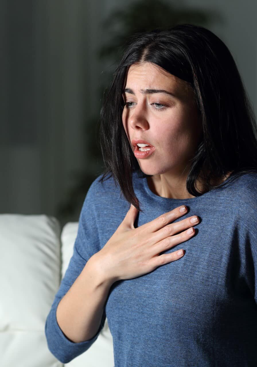 Woman with asthma on couch asthma